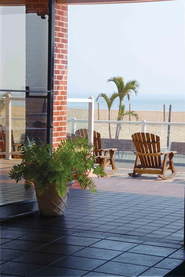 The Plim Plaza Hotel featurs a large from porch filled with rocking chairs overlooking the Ocean City beach and Atlantic Ocean