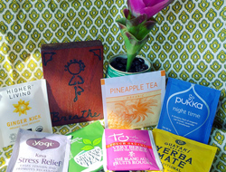 various teas on a table with a flower